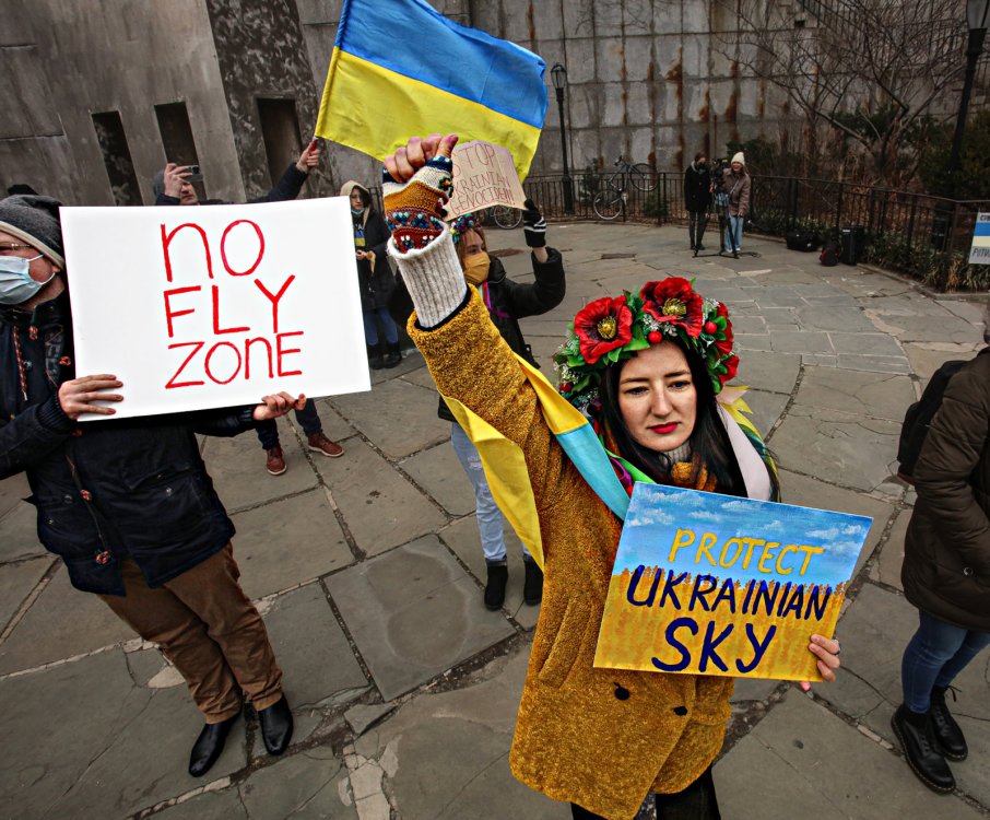 Wearing traditional Ukrainian flower headbands, a protester shouts “Protect Ukrainian sky!” Photo by Dean Moses